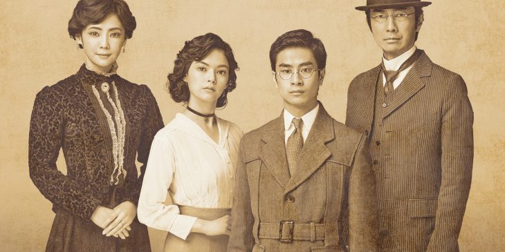 Vintage monochrome photo scan, ca. 1912. Young woman with victorian hairdo and fashionable high-necked blouse sitting on a classic bench.